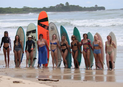 women doing vinyasa yoga flow on rooftop with ocean views